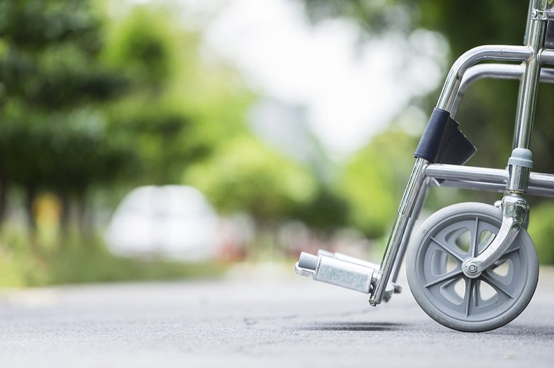 Empty wheelchair parked in park wheelchair tile / Getty Images
