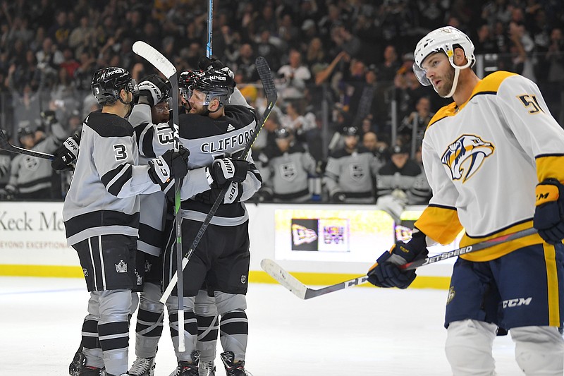 AP photo by Mark J. Terrill / Los Angeles Kings left wing Kyle Clifford, back right, celebrates his goal with teammates as Nashville Predators left wing Austin Watson skates by during the second period of Saturday night's game.