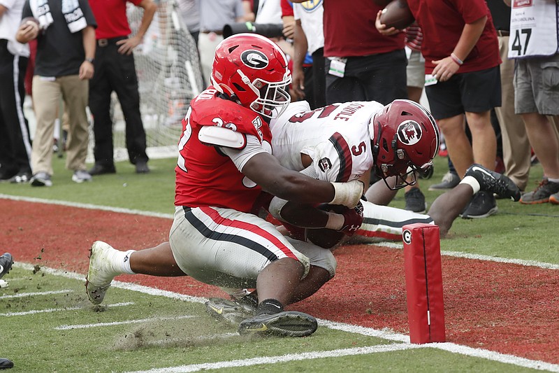 AP photo by John Bazemore / South Carolina running back Rico Dowdle is stopped short of the goal line by Georgia linebacker Nate McBride during Saturday's game in Athens, Ga.