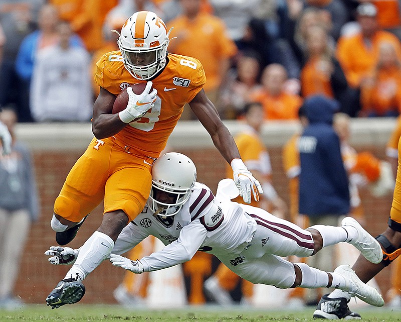 AP photo by Wade Payne / Tennessee running back Ty Chandler tries to evade Mississippi State cornerback Cameron Dantzler during the second half of Saturday's game in Knoxville.