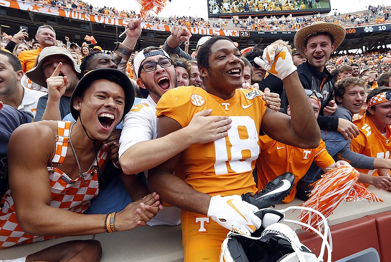 AP photo by Wade Payne / Tennessee safety Nigel Warrior celebrates with fans after the Volunteers' 20-10 win over Mississippi State on Saturday at Neyland Stadium.