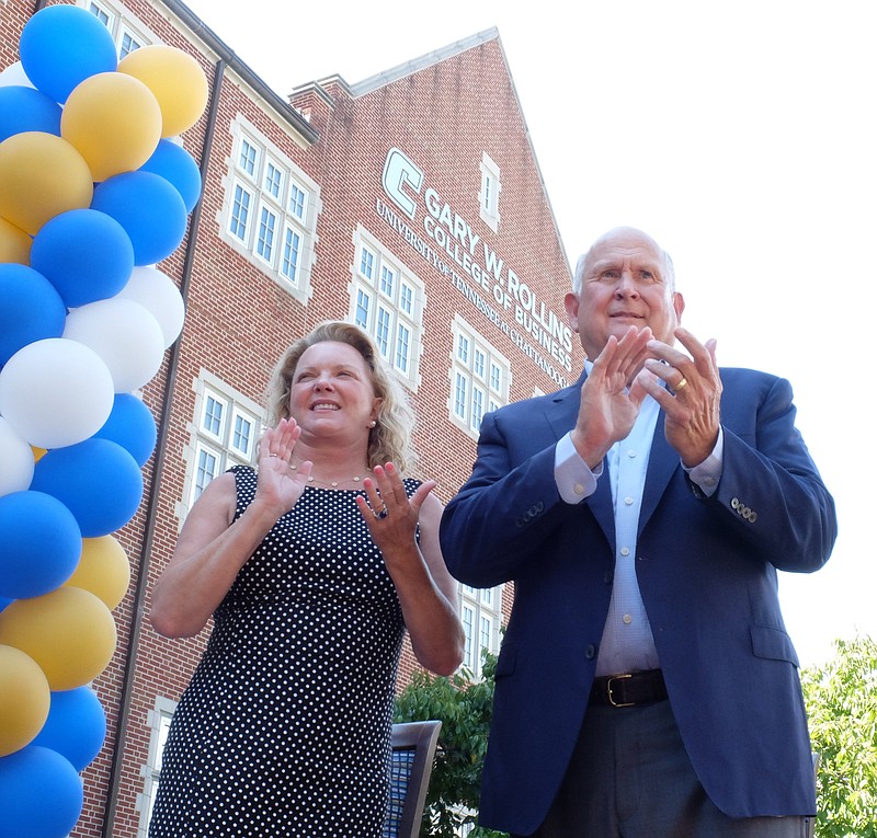University of Chattanooga graduate Gary W. Rollins, right, and his wife Kathleen stand in front of the Gary W. Rollins College of Business Thursday during a campus-wide celebration of their $40-million gift to the school. The gift was the largest single gift in the history of the University of Tennessee at Chattanooga. Staff photo by Tim Barber

