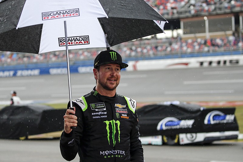 AP photo by Butch Dill / NASCAR driver Kurt Busch walks back to the garage during a rain delay for Sunday's Cup Series race at Talladega Superspeedway in Alabama.