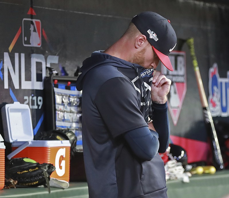 Atlanta Braves pitcher Mike Foltynewicz stands in the dugout during the ninth inning of the team's 13-1 loss to the St. Louis Cardinals during Game 5 of a baseball National League Division Series on Wednesday, Oct. 9, 2019, in Atlanta. The Cardinals advanced to the NL Championship Series. (Curtis Compton/Atlanta Journal-Constitution via AP)