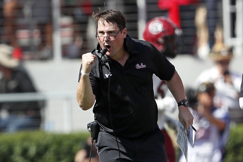 AP photo by John Bazemore / South Carolina football coach Will Muschamp celebrates after the Gamecocks returned an interception for a touchdown during the first half of Saturday's game at Georgia.