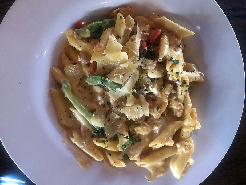 Parkway Pourhouse's gator sausage and chicken pasta features penne pasta tossed in a Cajun alfredo sauce with green peppers and cherry tomatoes. / Photo by Kate Brennan