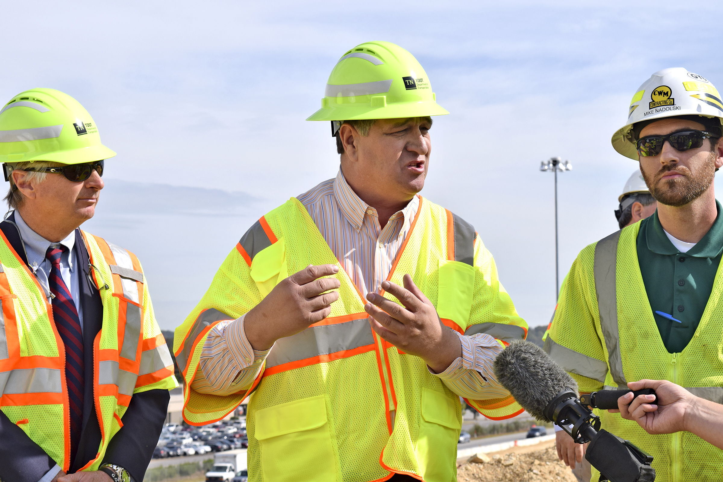 Staff Photo by Robin Rudd/ Paul Degges TDOT Deputy Commissioner/Chief Engineer discusses the future layout of the I-75/I-24 interchange. Listening, at left, is TDOT Commissioner Clay Bright, at right, Mike Nadolski project manager for C.W. Matthews Contracting. Tennessee Department of Transportation Commissioner Clay Bright, along with state and local elected officials, visited the I-75/I-24 interchange modification project in Chattanooga, Hamilton County on Tuesday, October 15, 2019.