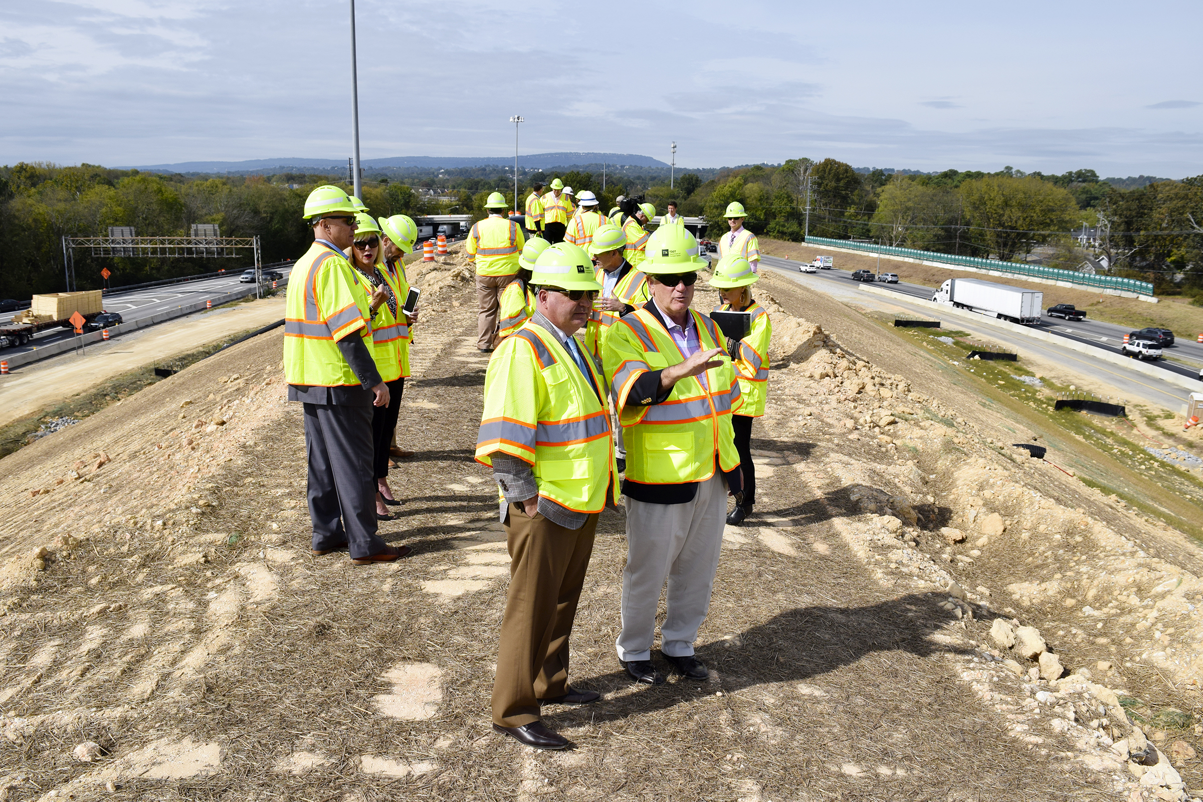 Staff Photo by Robin Rudd/ From left in foreground, Cleveland Mayor Kevin Brooks and State Senator Todd Gardenhire discuss the I-75/I-24 project. Mount Matthews is the playful name given to the large mount between I-75 and I-24. Tennessee Department of Transportation Commissioner Clay Bright, along with state and local elected officials, visited the I-75/I-24 interchange modification project in Chattanooga, Hamilton County on Tuesday, October 15, 2019.
