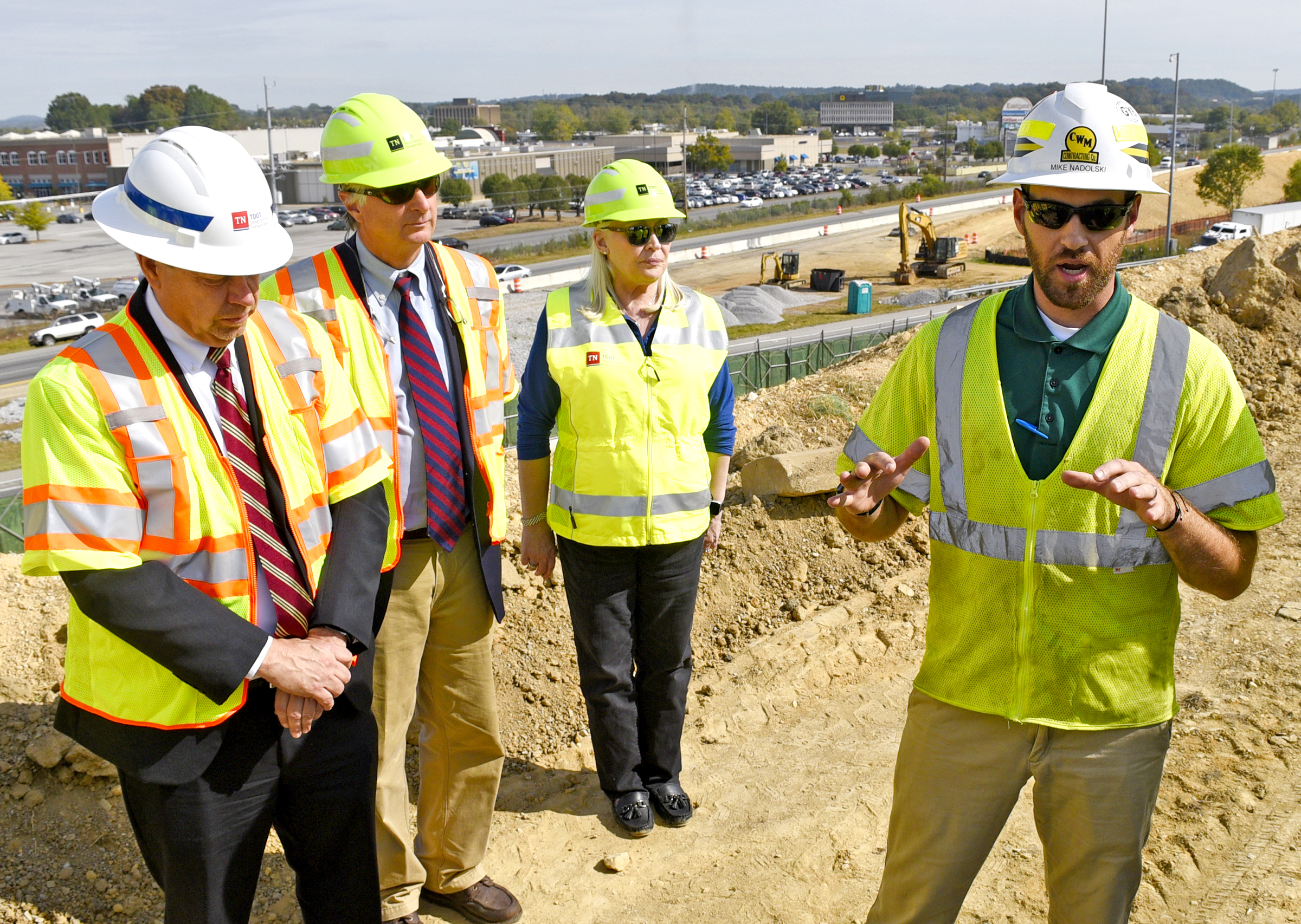 Staff Photo by Robin Rudd/ Mike Nadolski, project manager for C.W. Matthews Contracting Company, Inc., right, explains the progress of the modification. Listening from left are, Joe Deering TDOT Region 2 Director/Assistant Chief Engineer, Clay Bright TDOT Commissioner, Jennifer Flynn Region 2 Community Relations Officer and Paul Degges TDOT Deputy Commissioner/Chief Engineer. Tennessee Department of Transportation Commissioner Clay Bright, along with state and local elected officials, visited the I-75/I-24 interchange modification project in Chattanooga, Hamilton County on Tuesday, October 15, 2019.