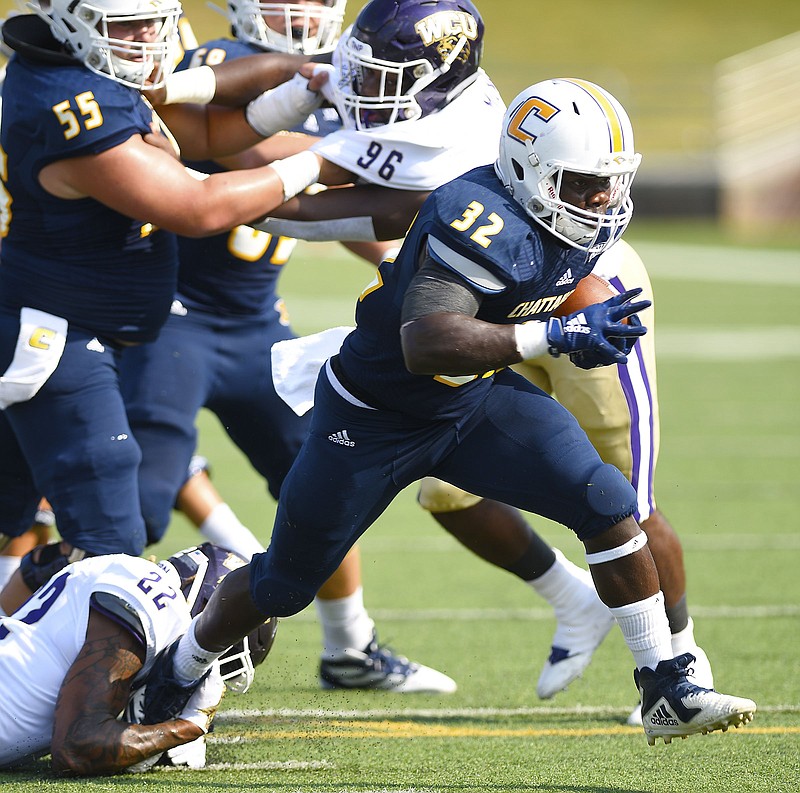 Staff Photo by Robin Rudd / UTC's Ailym Ford breaks free of Western Carolina's Jermichael White (22) to score a Moc touchdown.  The University of Tennessee at Chattanooga hosted the Western Carolina in a Southern Conference football game on September 28, 2019.  Today was homecoming for UTC. 