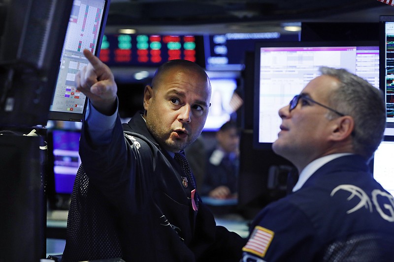 In this Oct. 7, 2019, file photo specialists Mario Picone, left, and Anthony Rinaldi work on the floor of the New York Stock Exchange. The U.S. stock market opens at 9:30 a.m. EDT on Monday, Oct. 14. (AP Photo/Richard Drew, File)