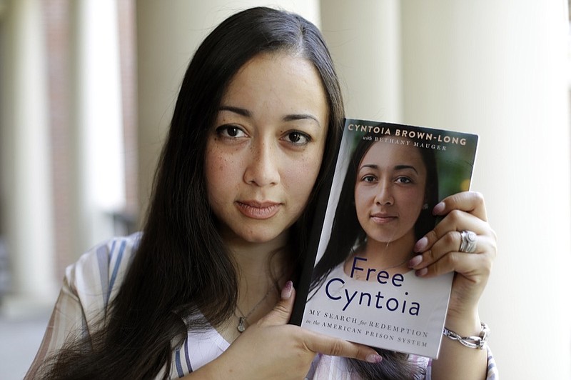 In this Sept. 20, 2019, photo, Cynthia Brown-Long holds a copy of her book, "Free Cyntoia: My Search for Redemption in the American Prison System," in Nashville, Tenn. (AP Photo/Mark Humphrey)


