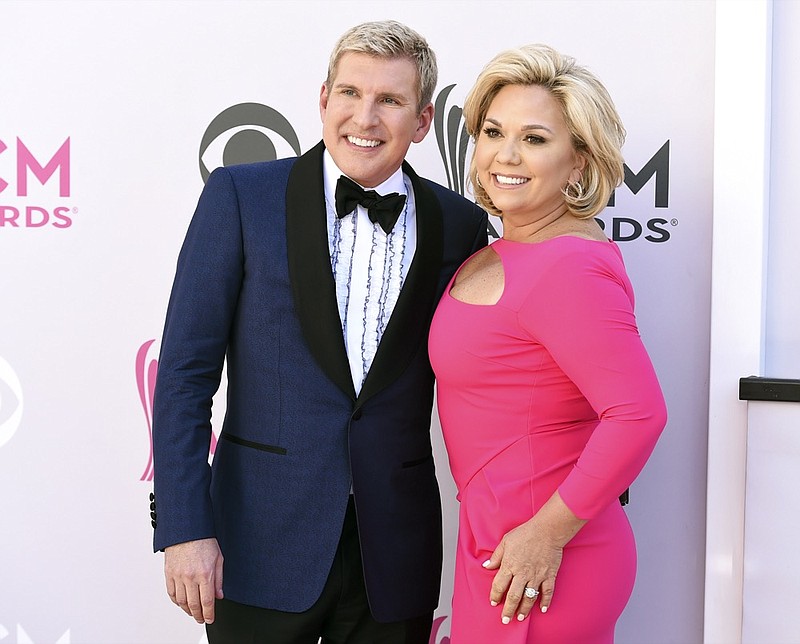 FILE - This April 2, 2017 file photo shows Todd Chrisley, left, and his wife Julie Chrisley at the 52nd annual Academy of Country Music Awards in Las Vegas. (Photo by Jordan Strauss/Invision/AP, File)


