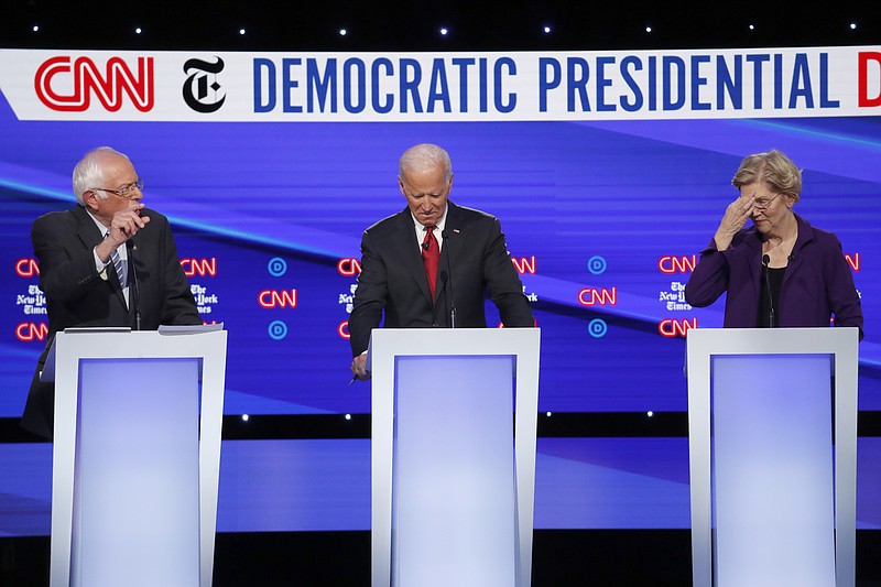 Democratic presidential candidate Sen. Bernie Sanders, I-Vt., left, former Vice President Joe Biden and Sen. Elizabeth Warren, D-Mass., participate in a Democratic presidential primary debate hosted by CNN/New York Times at Otterbein University, Tuesday, Oct. 15, 2019, in Westerville, Ohio. (AP Photo/John Minchillo)