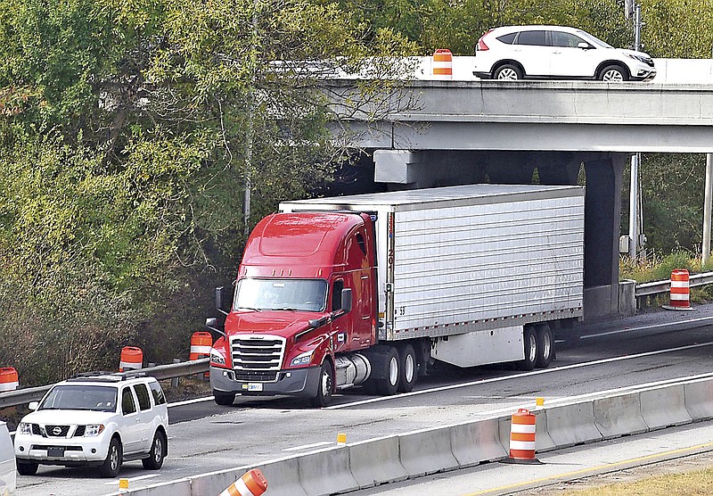 Staff Photo by Robin Rudd/  A tractor-trailer truck passes underneath the Spring Creek Road Bridge as it leaves westbound I-24 to merge onto southbound I-75 on Tuesday, October 15, 2019.