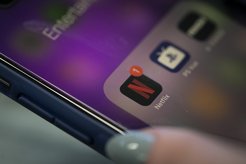 This Tuesday, Oct. 8, 2019, photo shows the Netflix app on an iPhone in New York. Netflix reports financial results Wednesday, Oct. 16. (AP Photo/Jenny Kane)