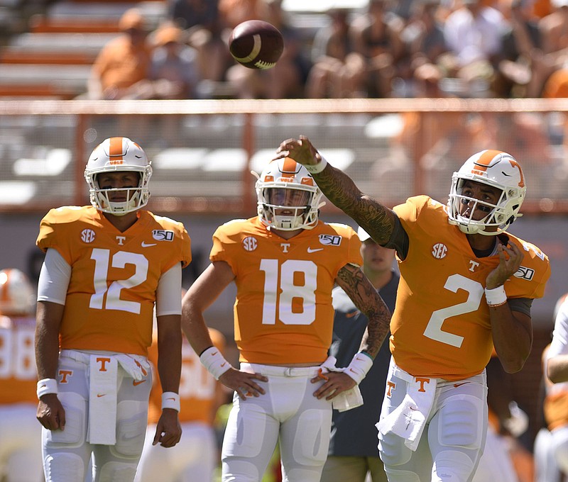 Staff Photo by Robin Rudd / J.T. Shrout (12) and Brian Maurer (18) watch fellow Tennessee Vols quarterback Jarrett Guarantano warm up for the season opener against Georgia State on Aug. 31 in Knoxville.