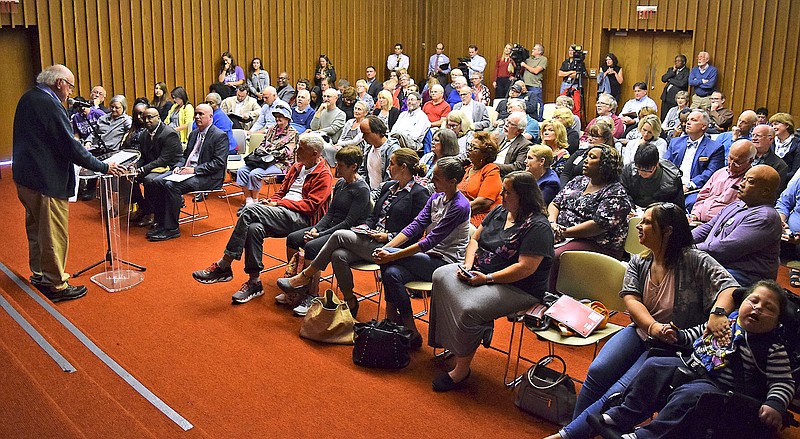 Staff Photo by Robin Rudd/  Dr. Cliff Cleavland, left, addresses a full meeting room. A public hearing on Gov. Bill Lee's Medicaid block grant proposal took place at the Chattanooga Public Library on October 16, 2019.