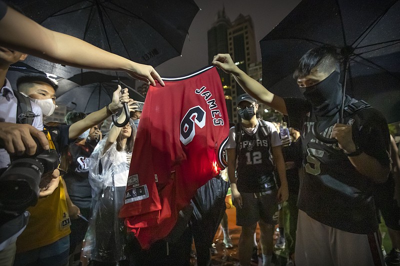 Demonstrators set a Lebron James jersey on fire during a rally at the Southorn Playground in Hong Kong, Tuesday, Oct. 15, 2019. Protesters in Hong Kong have thrown basketballs at a photo of LeBron James and chanted their anger about comments the Los Angeles Lakers star made about free speech during a rally in support of NBA commissioner Adam Silver and Houston Rockets general manager Daryl Morey, whose tweet in support of the Hong Kong protests touched off a firestorm of controversy in China. (AP Photo/Mark Schiefelbein)


