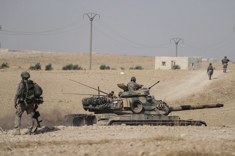 Turkish tanks and troops stationed near Syrian town of Manbij, Syria, Tuesday. Oct. 15, 2019. Russia moved to fill the void left by the United States in northern Syria on Tuesday, deploying troops to keep apart advancing Syrian government and Turkish forces.(Ugur Can/DHA via AP)
