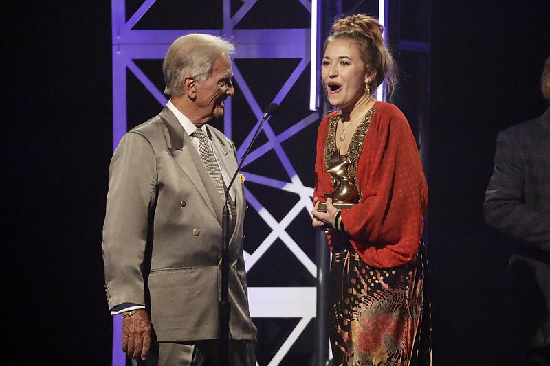 Lauren Daigle, right, accepts the song of the year award from Pat Boone, left, during the Dove Awards on Tuesday, Oct. 15, 2019, in Nashville, Tenn. (AP Photo/Mark Humphrey)