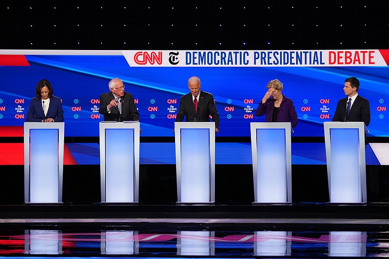 New York Times photo / Sen. Elizabeth Warren (D-Mass.), second from right, reacts during the Democratic presidential debate Tuesday. From left is, Sen. Kamala Harris (D-Calif.), Sen. Bernie Sanders (I-Vt.), former Vice President Joe Biden, Warren and Mayor Pete Buttigieg of South Bend, Ind.