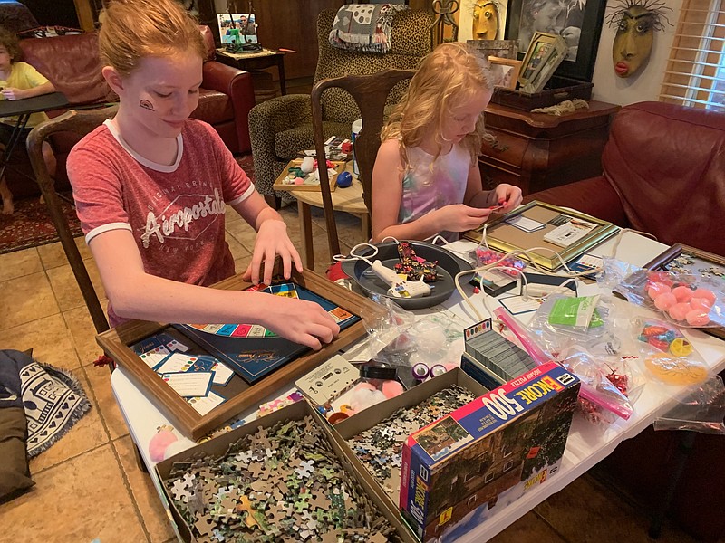 Photo by Karen Nazor Hill / Sisters Tilleigh, 12, and Evie, 9, work on art projects used as Swim the Suck trophies during the early part of their fall break.