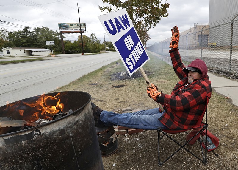 Ray Geyser, a 21-year General Motors employee, pickets outside the General Motors Fabrication Division, Wednesday, Oct. 16, 2019, in Parma, Ohio. Bargainers for General Motors and the United Auto Workers reached a tentative contract deal on Wednesday that could end a monthlong strike that brought the company's U.S. factories to a standstill. (AP Photo/Tony Dejak)