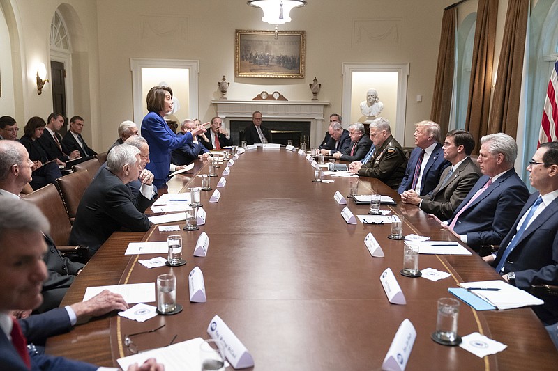 In this photo released by the White House, President Donald Trump, center right, meets with House Speaker Nancy Pelosi, standing left, Congressional leadership and others, Wednesday, Oct. 16, 2019, in the Cabinet Room of the White House in Washington. (Official White House Photo by Shealah Craighead via AP)


