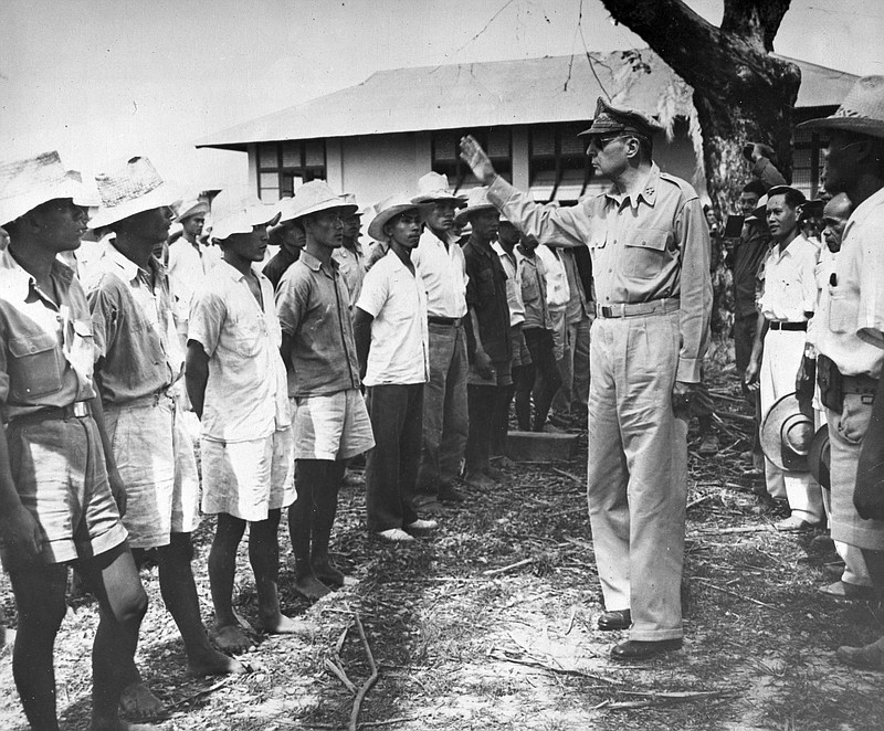 Gen. Douglas MacArthur gestures as he talks to a group of attentive Filipino guerrillas near Bayambang, on Luzon Island, in the Philippines, Jan. 29, 1945. (AP File Photo/Max Desfor)