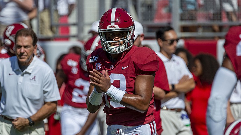 AP photo by Vasha Hunt / Alabama football coach Nick Saban, left, looks on as junior quarterback Tua Tagovailoa warms up for the Crimson Tide's home game against Southern Miss on Sept. 21.