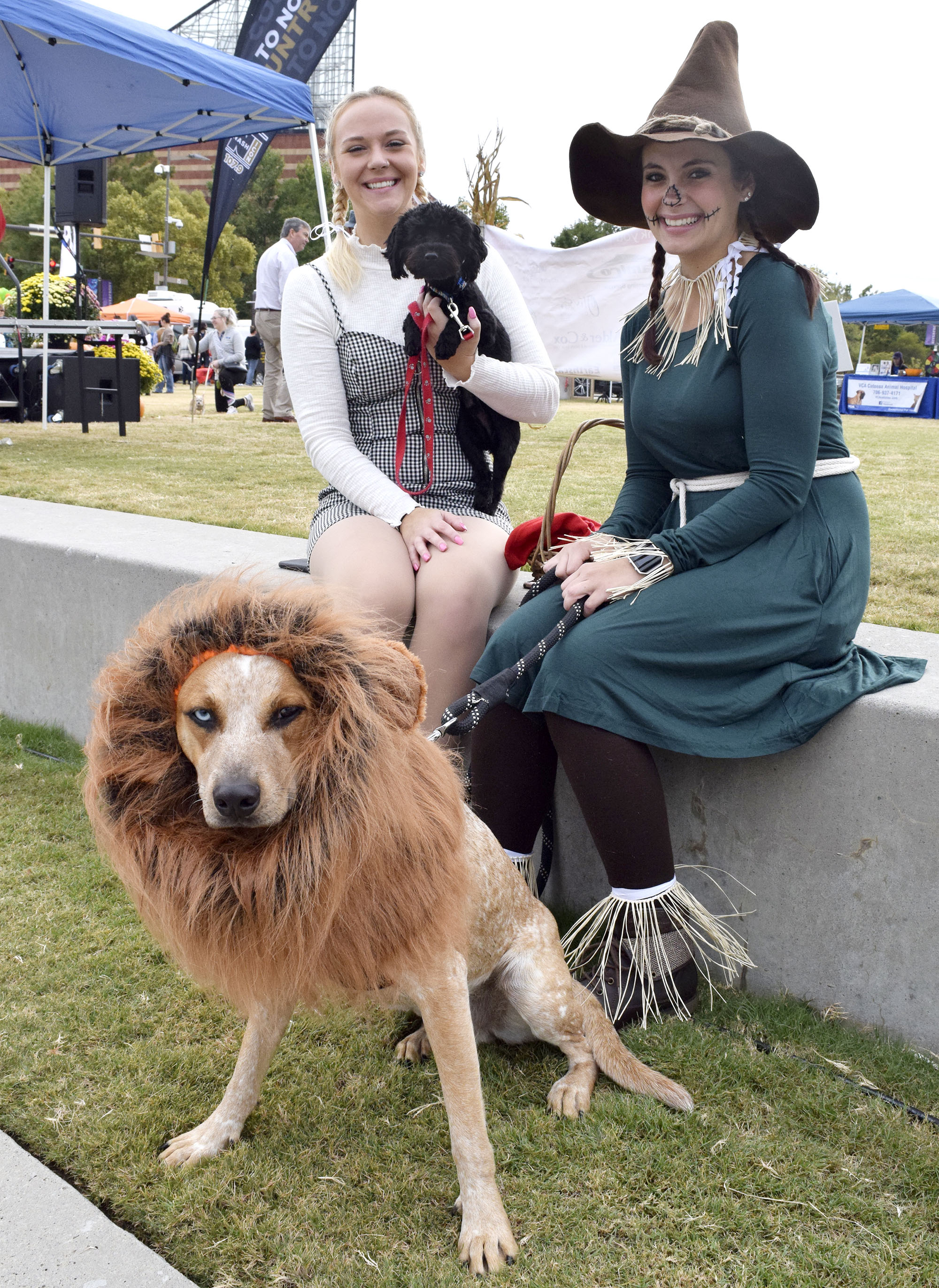 Staff Photo by Robin Rudd/ Dressed as Dorothy, from the Wizard of Oz, Caitlin Yager holds Tooto standin, Dak, while Samantha Yager is the Scarecrow and Bjorn is the Cowardly Lion. Hundreds of animals lovers gathered to raise money for the Humane Educational Society at the 17th annual Paws in the Park. The event included a walk, dog and human costume contest, and a dog cake-eating contest. Ross's Landing Park was the site of the event on October 19, 2019.