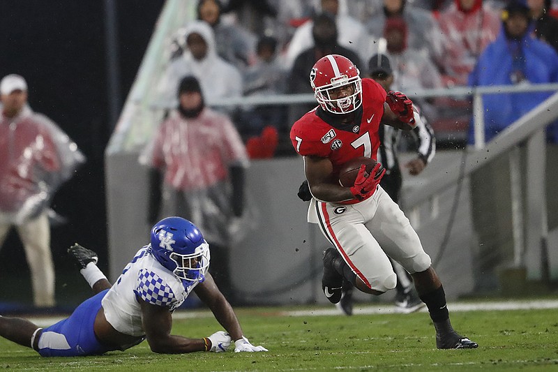 AP photo by John Bazemore / Georgia running back D'Andre Swift breaks away from a Kentucky defender during Saturday night's game in Athens, Ga. Swift rushed for 179 yards and two touchdowns as the Bulldogs won 21-0.