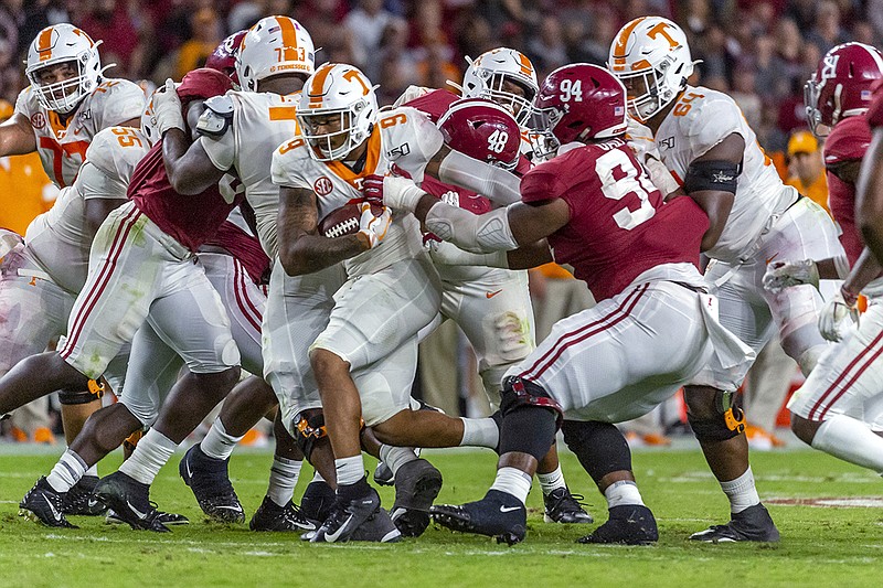 AP photo by Vasha Hunt / Tennessee running back Tim Jordan (9) cuts inside past Alabama defensive lineman D.J. Dale (94) during the second half of their SEC matchup Saturday night in Tuscaloosa, Ala.