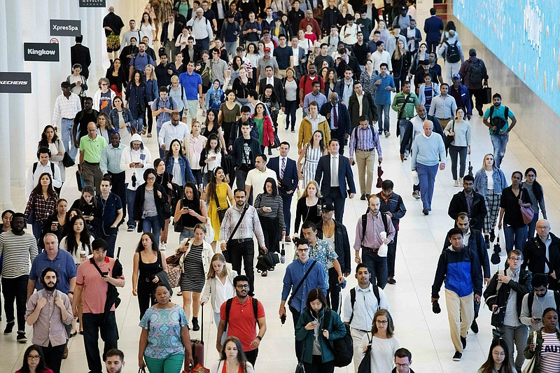 FILE - In this June 21, 2019, file photo commuters walk through a corridor in the World Trade Center Transportation Hub in New York. Women business owners can find it hard to be taken seriously even as their companies grow into multimillion-dollar enterprises. That’s the finding of a report released last week by Babson College and Bank of America that analyzed the challenges women encountered as they were building their companies.  (AP Photo/Mark Lennihan)