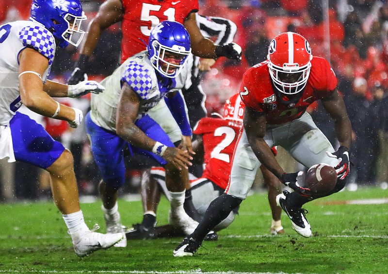 Georgia photo/Tony Walsh / Georgia junior safety Richard LeCounte scoops up a fumble during Saturday night's 21-0 victory over Kentucky in Sanford Stadium.