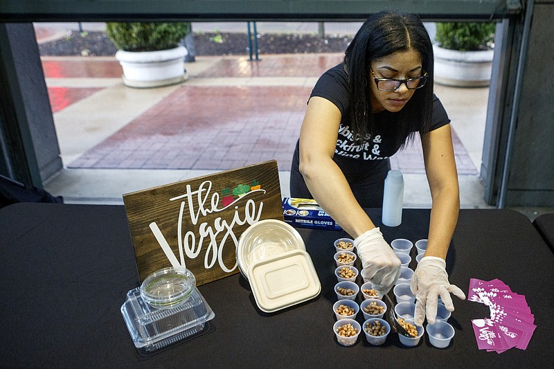 Staff photo by C.B. Schmelter / The Veggie founder Adyre Mason sets up samples of food during the Will This Float?: Female Founders Edition competition at Miller Plaza on Monday, Oct. 21, 2019 in Chattanooga, Tenn. Mason won the competition and the $3,000 prize.