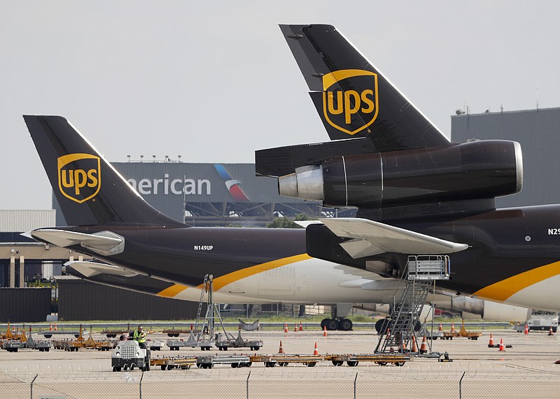 In this June 24, 2019, photo workers prepare to unload a UPS aircraft after it arrived at Dallas-Fort Worth International Airport in Grapevine, Texas. United Parcel Service Inc. reports financial earns on Tuesday, Oct. 22, 2019. (AP Photo/Tony Gutierrez)