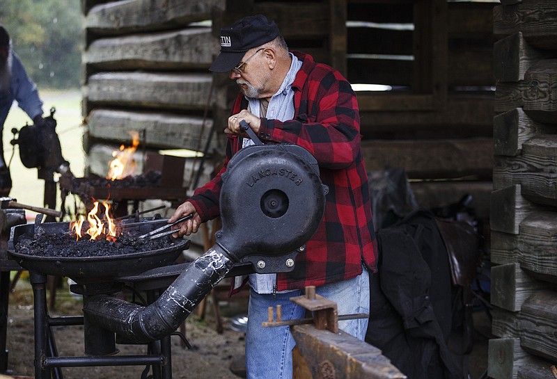 Staff File Photo / Blacksmith Ray Brown demonstrated making horse shoes at a previous Red Clay Pow Wow at Red Clay State Park. This weekend's pow wow will include demonstrations in bow-and-arrow making, pottery and basketry.