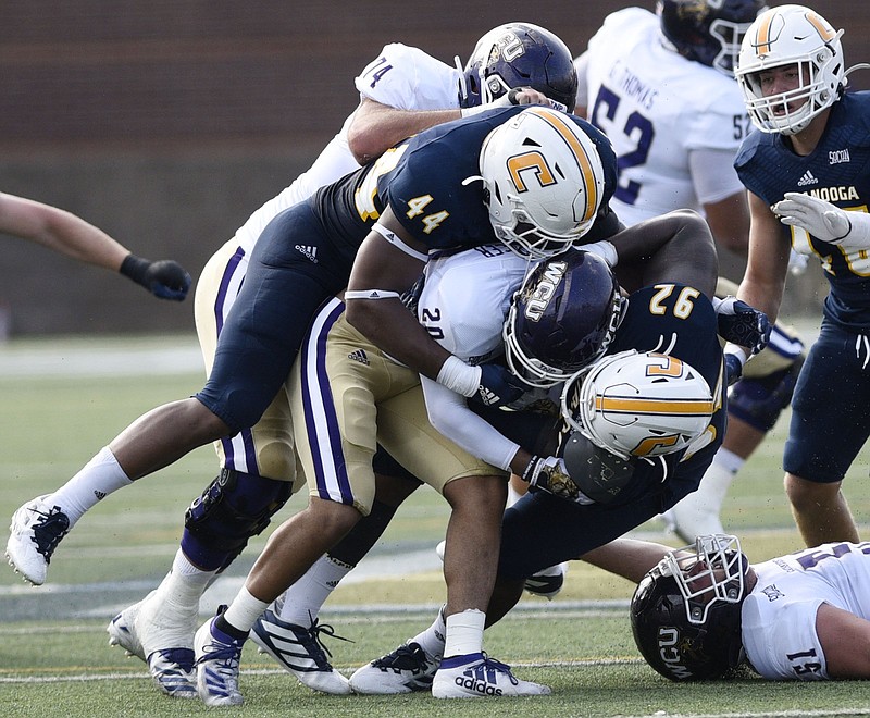 Staff Photo by Robin Rudd/  UTC's Khayyan Edwards (44) and Telvin Jones (92) stop Western's Donnavan Spencer (20) in the backfield.  The University of Tennessee at Chattanooga hosted the Western Carolina in a Southern Conference football game on September 28, 2019.  Today was homecoming for UTC. 