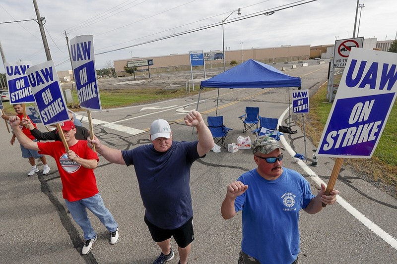 FILE - In this Sept. 16, 2019, file photo picketers carry signs at one of the gates outside the closed General Motors automobile assembly plant in Lordstown, Ohio. (AP Photo/Keith Srakocic, File)


