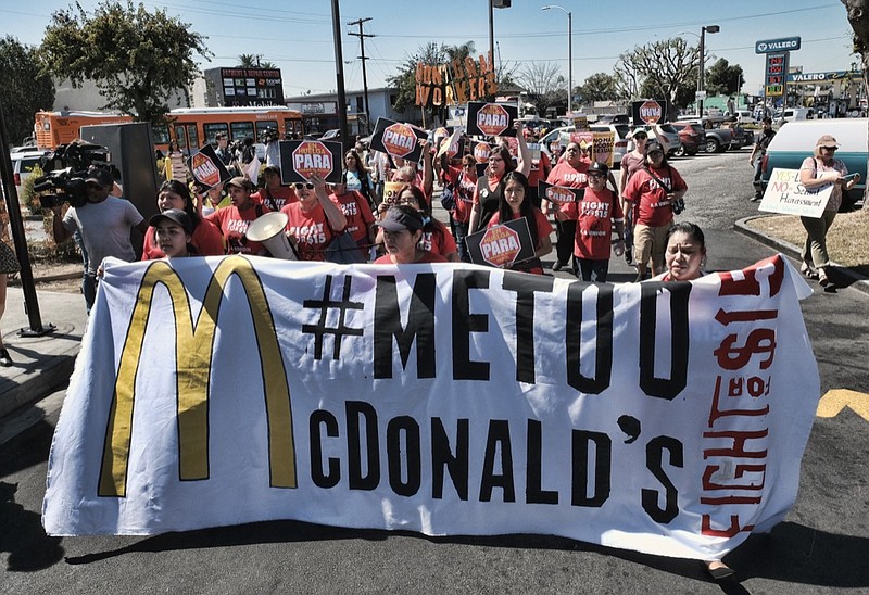 FILE - In this Sept. 18, 2018, file photo, McDonald's workers carry a banner and march towards a McDonalds in south Los Angeles. (AP Photo/Richard Vogel, File)


