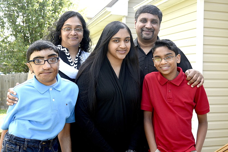 Staff file photo by Robin Rudd / From left, Philip, Susan, Sara, Santhosh and Caleb Mathews pose for a family portrait. Philip died on Tuesday after a brief illness.