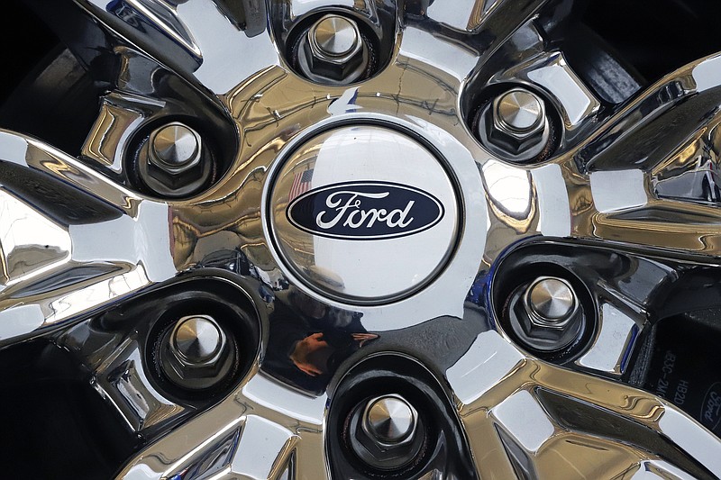 FILE- In this Feb. 14, 2019, file photo a wheel on a 2019 Ford Expedition 4x4 is displayed at the 2019 Pittsburgh International Auto Show in Pittsburgh. Ford Motor Co. reports financial earns on Wednesday, Oct. 23. (AP Photo/Gene J. Puskar, File)