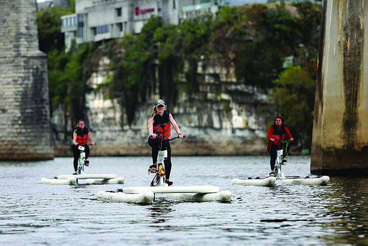 Staff photo by Erin O. Smith / Jennifer Bardoner, Chatter Magazine and Community News editor; Sunny Montgomery, reporter and Get Out digital magazine editor; and Sabrina Bodon, reporter for Community News and Chatter, ride on Schiller paddle bikes through Adventure Sports Innovation Monday, September 23, 2019 on the Tennessee River in Chattanooga, Tennessee. Adventure Sports Innovation has a variety of electric personal transportation devices as well as virtual reality experiences.