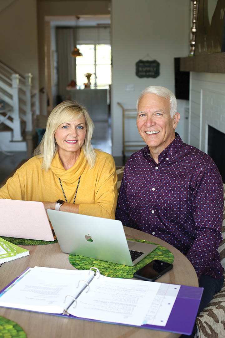 Staff photo by Erin O. Smith / Sheri and Mike Goins pose for a photo at their home Thursday, Oct. 3, 2019 in Chattanooga, Tennessee. After retiring, the two have become trained health and life coaches and also began long-distance cycling together.