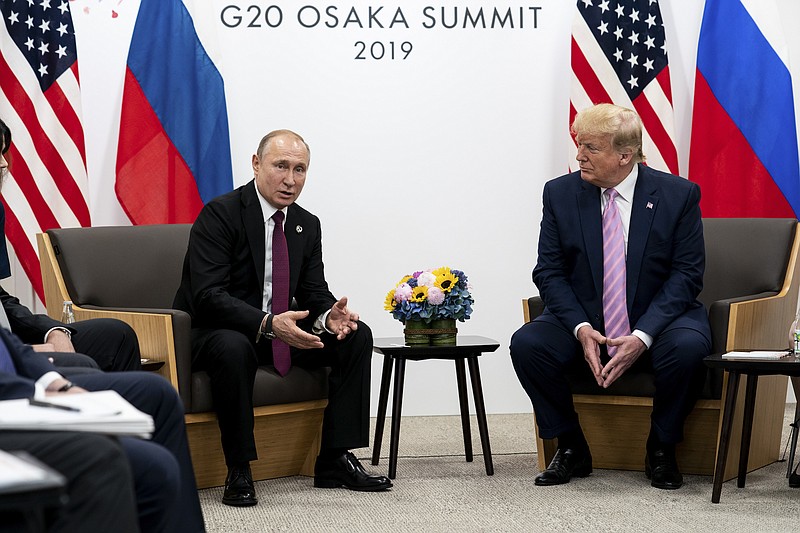 File photo by Erin Schaff of The New York Times / President Vladimir Putin of Russia and President Donald Trump participate in a bilateral meeting during the G-20 summit in Osaka, Japan in June 2019.