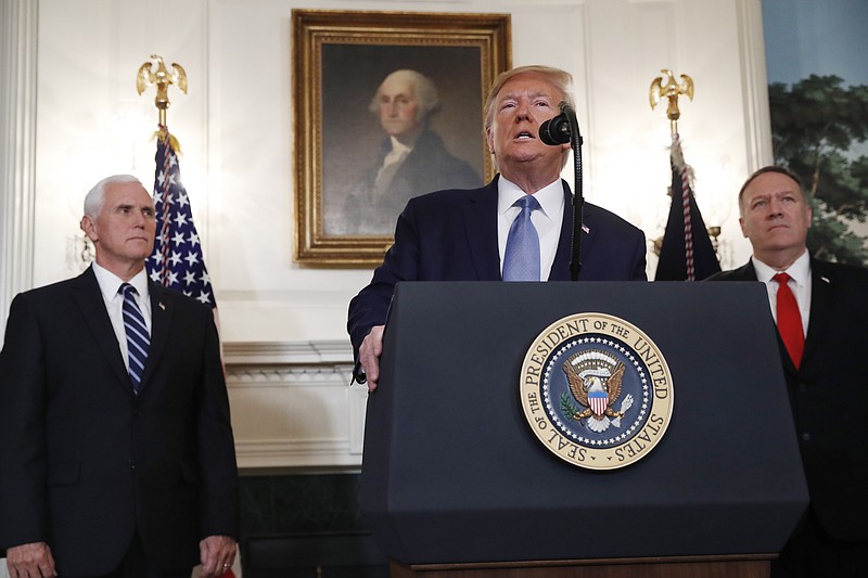 President Donald Trump, accompanied by Vice President Mike Pence, left, and Secretary of State Mike Pompeo, speaks Wednesday, Oct. 23, 2019, in the Diplomatic Room of the White House in Washington. (AP Photo/Jacquelyn Martin)