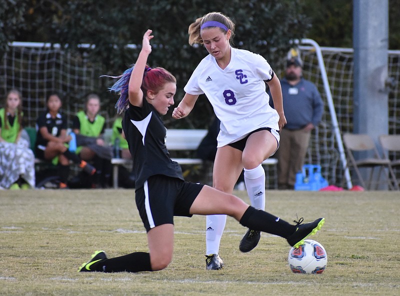 Staff photo by Patrick MacCoon / East Hamilton eighth-grader Mia Moore takes the ball away from Sequatchie County's Channing Barker. East Hamilton won the Region 4-AA championship match 2-1 at home Thursday.