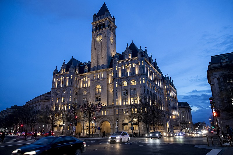 FILE - In this Jan. 23, 2019, file photo, the Trump International Hotel near sunset in Washington. A federal appeals court will reconsider a ruling from a three-judge panel that threw out a lawsuit accusing President Donald Trump of illegally profiting off the presidency through his luxury Washington hotel. The Richmond-based 4th U.S. Circuit Court of Appeals agreed Tuesday, Oct. 15, to hold a hearing before the full court of 15 judges. Arguments are scheduled for Dec. 12. (AP Photo/Alex Brandon, File)